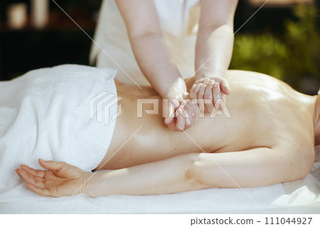 Medical massage therapist in spa salon do therapeutic massage 111044927