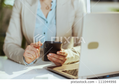 Modern woman employee in green office using phone Modern woman employee in green office using phone 111044998
