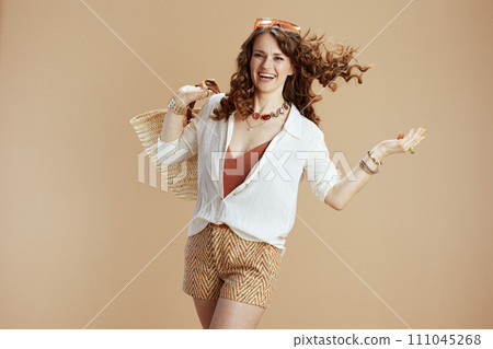 happy trendy woman in blouse and shorts on beige happy trendy woman in blouse and shorts on beige 111045268