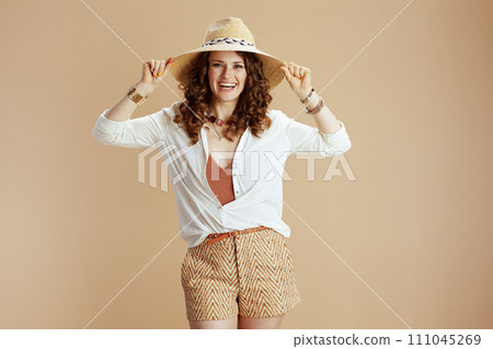 smiling stylish woman in blouse and shorts smiling stylish woman in blouse and shorts 111045269