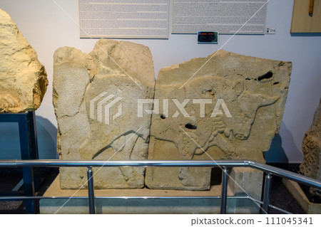 Bas-relief of a bull on a stone, a museum piece in the museum of antiquities of Antalya. 111045341