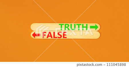 Truth or false symbol. Concept word Truth or False on beautiful wooden stick. Beautiful orange table orange background. Business and truth or false concept. Copy space. Truth or false symbol. Concept word Truth or False on beautiful wooden stick. Beautiful orange table orange background. Business and truth or false concept. Copy space. 111045898