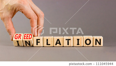 Inflation or greedflation symbol. Concept word Inflation Greedflation on beautiful wooden cubes. Beautiful grey background. Businessman hand. Business inflation greedflation concept. Copy space. 111045944