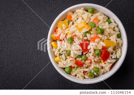 Delicious white boiled rice with vegetables, sweet peppers, carrots, peas, salt and spices Delicious white boiled rice with vegetables, sweet peppers, carrots, peas, salt and spices 111046154