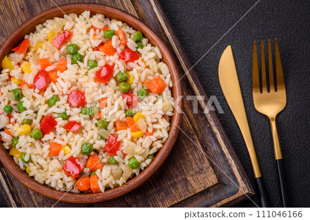 Delicious white boiled rice with vegetables, sweet peppers, carrots, peas, salt and spices Delicious white boiled rice with vegetables, sweet peppers, carrots, peas, salt and spices 111046166