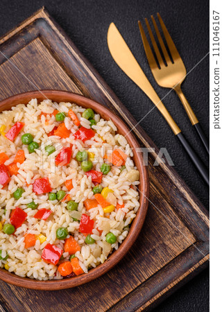 Delicious white boiled rice with vegetables, sweet peppers, carrots, peas, salt and spices 111046167