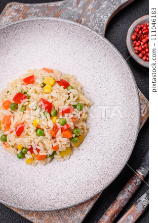 Delicious white boiled rice with vegetables, sweet peppers, carrots, peas, salt and spices Delicious white boiled rice with vegetables, sweet peppers, carrots, peas, salt and spices 111046183
