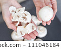 The process of peeling mushrooms. A woman's hands peel mushrooms with a knife, close-up. Cooking mushrooms. 111046184