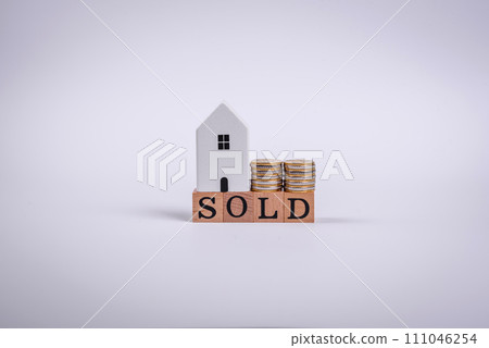 The inscription Sold made of wooden cubes on a plain background 111046254