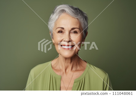 Portrait of smiling senior woman with grey hair against green background Portrait of smiling senior woman with grey hair against green background 111048061