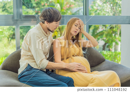 Expectant woman feels unwell, husband comforts and reassures her during a challenging pregnancy 111048192