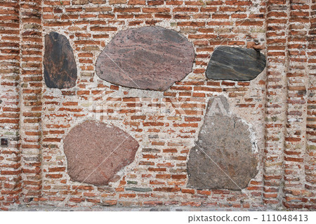 The texture of the old ancient medieval antique stone hard peeling cracked brick wall The texture of the old ancient medieval antique stone hard peeling cracked brick wall 111048413