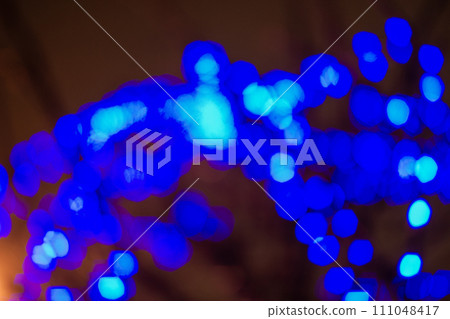 Beautiful holiday bokeh of blue swag. 111048417