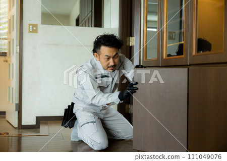 A worker inspecting fittings 111049076