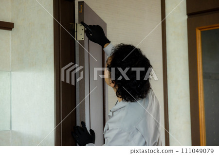 A worker inspecting fittings 111049079