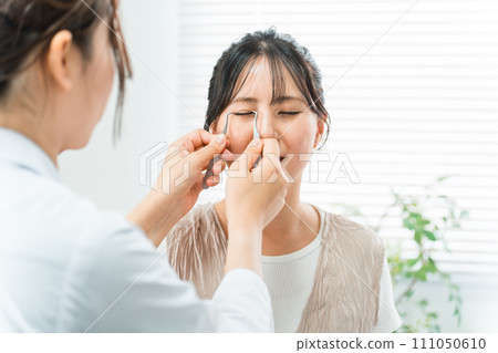 A female patient and a cosmetic surgeon simulating double plastic surgery at a beauty clinic A female patient and a cosmetic surgeon simulating double plastic surgery at a beauty clinic 111050610