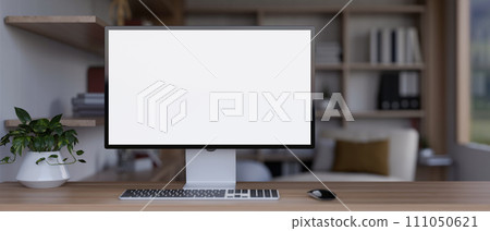 Front view image of a white-screen computer mockup on a wooden table in a modern living room. Front view image of a white-screen computer mockup on a wooden table in a modern living room. 111050621