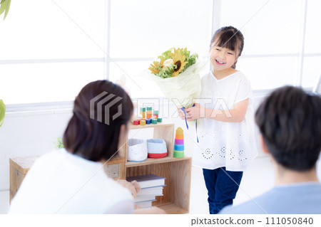 Family portrait: Girl giving a bouquet of flowers on anniversary Family portrait: Girl giving a bouquet of flowers on anniversary 111050840