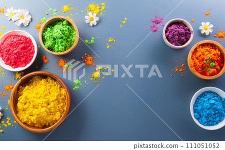 Happy Holi decoration, the indian festival.Top view of colorful holi powder on dark background. Happy Holi decoration, the indian festival.Top view of colorful holi powder on dark background. 111051052