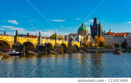 View of Prague, Charles bridge and the Vltava river with tourist boats floating View of Prague, Charles bridge and the Vltava river with tourist boats floating 111051464