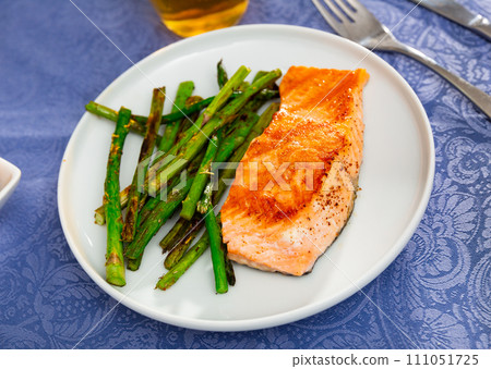 Fresh salmon steak with bunch of roasted asparagus 111051725