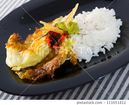 Cabbage in batter with rice and sauces on black plate 111051812