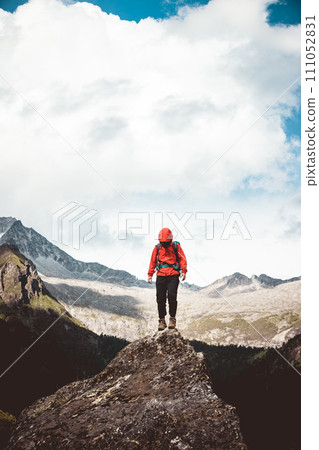 Woman hiker climbing to mountain top in tibet Woman hiker climbing to mountain top in tibet 111052831