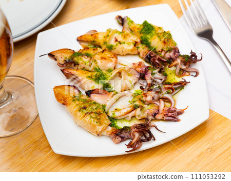 Fried calamari with pesto sauce served in a plate 111053292