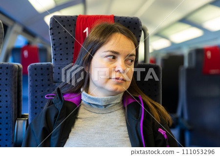 Portrait of woman sitting inside train Portrait of woman sitting inside train 111053296