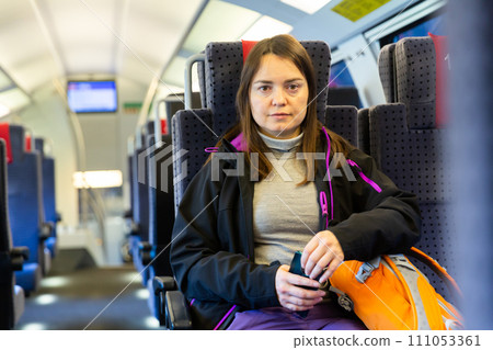 Portrait of woman sitting inside train 111053361