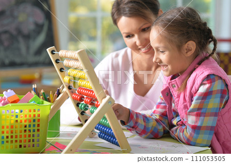 mother with little daughter counting with abacus 111053505