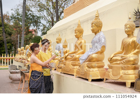 On Songkran Day, young Thai people wear Thai costumes to bathe Buddha statues and play on Songkran Day. On Songkran Day, young Thai people wear Thai costumes to bathe Buddha statues and play on Songkran Day. 111054924