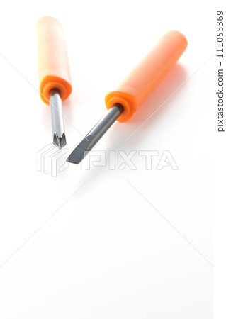 A photo of a Phillips screwdriver and a flathead screwdriver on a white background 111055369