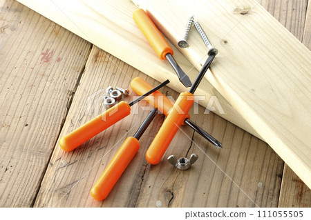 screwdriver and screw and wood 111055505