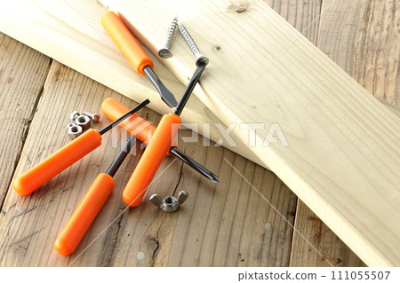 screwdriver and screw and wood 111055507