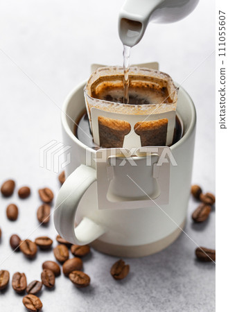 Drip coffee bag with ground coffee in cup Drip coffee bag with ground coffee in cup 111055607