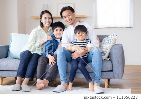 Family portrait A family sitting on the sofa with a smile Family portrait A family sitting on the sofa with a smile 111056228