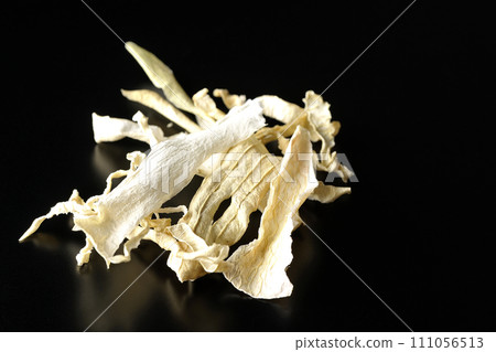 Dried radish skin photographed against a black background Dried radish skin photographed against a black background 111056513