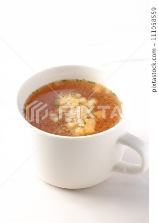 Hot onion consommé soup Hot onion consommé soup 111058559