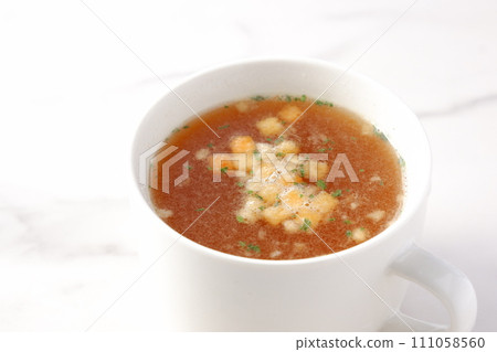Hot onion consommé soup Hot onion consommé soup 111058560