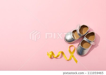 Silver children's shoes with a yellow ribbon Silver children's shoes with a yellow ribbon 111059465