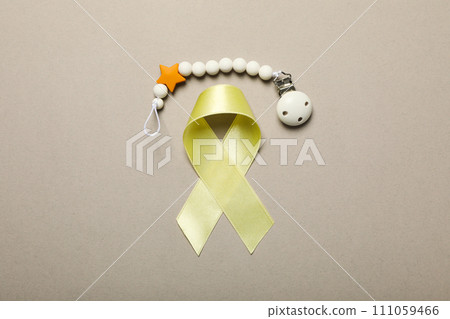 Yellow satin ribbon with a wrist bracelet on a light background 111059466