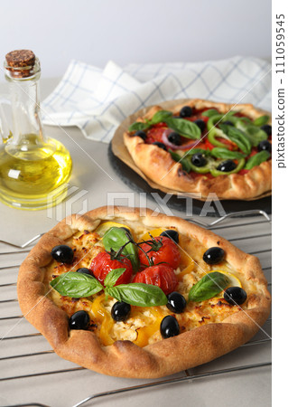 Freshly baked vegetable galettes on a metal tray 111059545