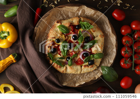 Freshly baked vegetable galette with fresh vegetables 111059546