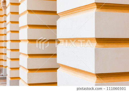 Abstract classic architecture details, white pillars with yellow stripes 111060301
