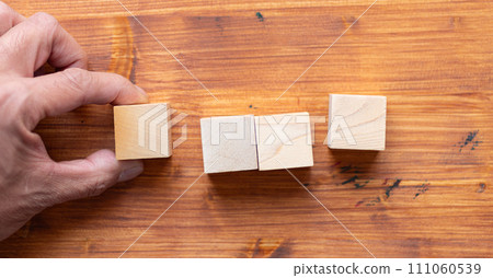 hand holding blank wooden block hand holding blank wooden block 111060539