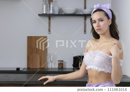 Beautiful girl in the kitchen. Woman in pajamas at home. Beautiful girl in the kitchen. Woman in pajamas at home. 111061018