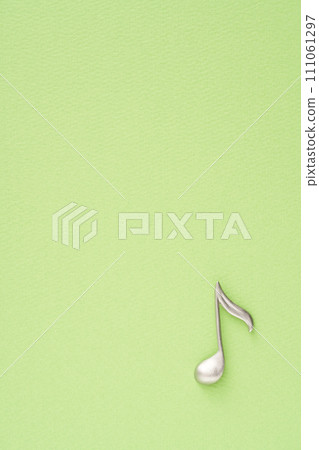 Music image: Eighth note object placed on yellow-green paper 111061297