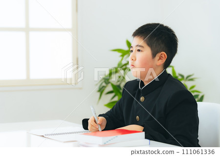 A male student studying wearing a school uniform 111061336