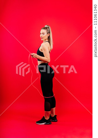 Happy fit woman over studio background. Smiling female fitness workout. Healthy lifestyle concept. Happy fit woman over studio background. Smiling female fitness workout. Healthy lifestyle concept. 111061340